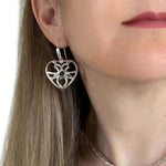 Silver Heart Earrings With A Puffed Openwork Finish with model - Nueve Sterling