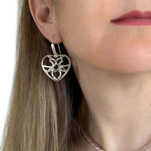 Silver Heart Earrings With A Puffed Openwork Finish with model - Nueve Sterling
