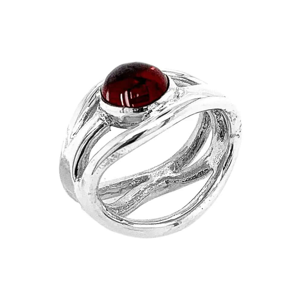 Side perspective view showcasing the clean contours of the openwork frame and the smooth bezel setting of the garnet cabochon.
