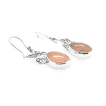 Side profile of the lightweight artisan earrings highlighting the high-polish finish and secure silver settings.