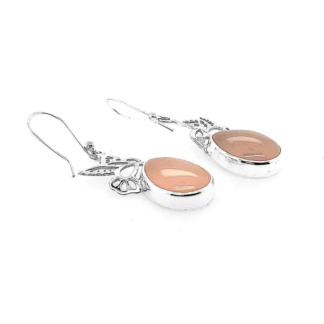 Side profile of the lightweight artisan earrings highlighting the high-polish finish and secure silver settings.