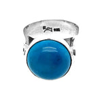 Front layout view of a handmade 950 silver statement ring showcasing an irregular, organically shaped natural turquoise gemstone.