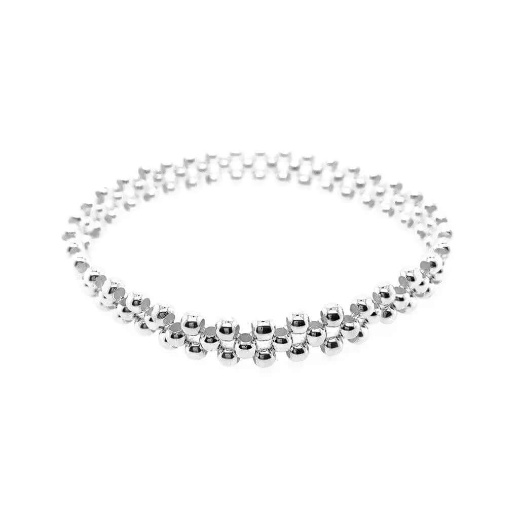Overhead layout view of a handmade 925 sterling silver triple-row small bead bracelet illustrating its structured alignment.
